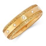 AN ANTIQUE PEARL BANGLE, 19TH CENTURY in high carat yellow gold, the band design set with five