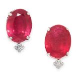 A PAIR OF RUBY AND DIAMOND STUD EARRINGS in platinum, each set with an oval cut ruby accented by a