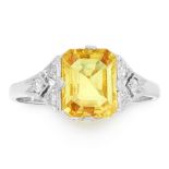 A YELLOW SAPPHIRE AND DIAMOND RING in platinum, set with an emerald cut yellow sapphire of 2.11