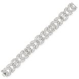 A DIAMOND BRACELET, 20TH CENTURY in platinum, formed of a series of geometric links, set with a trio