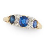 A SAPPHIRE AND DIAMOND DRESS RING in yellow gold, set with a trio of graduated oval cut sapphires