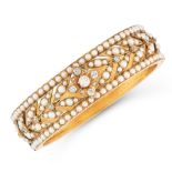 AN ANTIQUE VICTORIAN PEARL AND DIAMOND BANGLE in 15ct yellow gold, decorated in foliate motif set