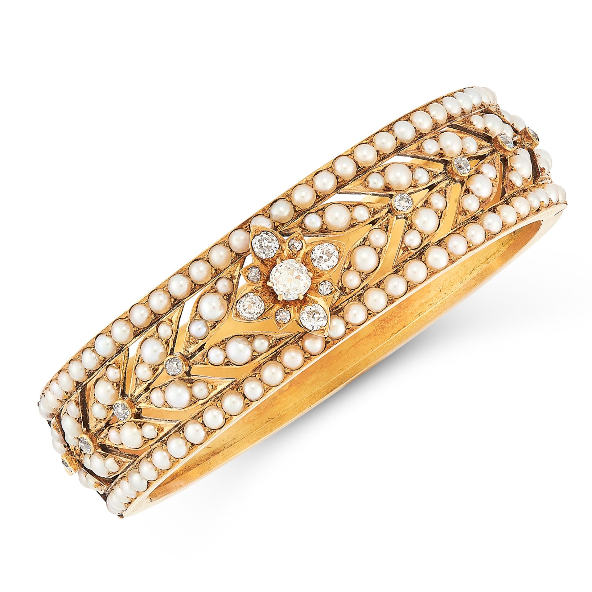 AN ANTIQUE VICTORIAN PEARL AND DIAMOND BANGLE in 15ct yellow gold, decorated in foliate motif set