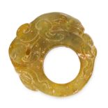 A CARVED JADE RING comprising of a single piece of polished jade, depicting a mythical creature