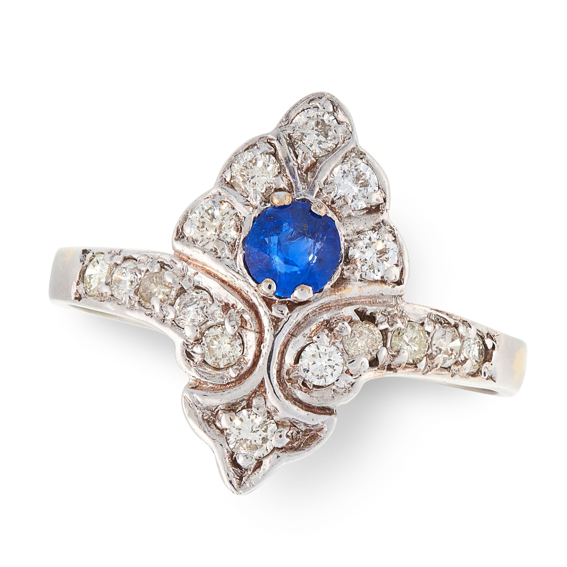 A SAPPHIRE AND DIAMOND DRESS RING the shield shaped face set with a round cut sapphire accented by