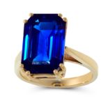 A 10.11 CARAT BURMA NO HEAT SAPPHIRE RING in yellow gold, set with a central emerald cut sapphire of