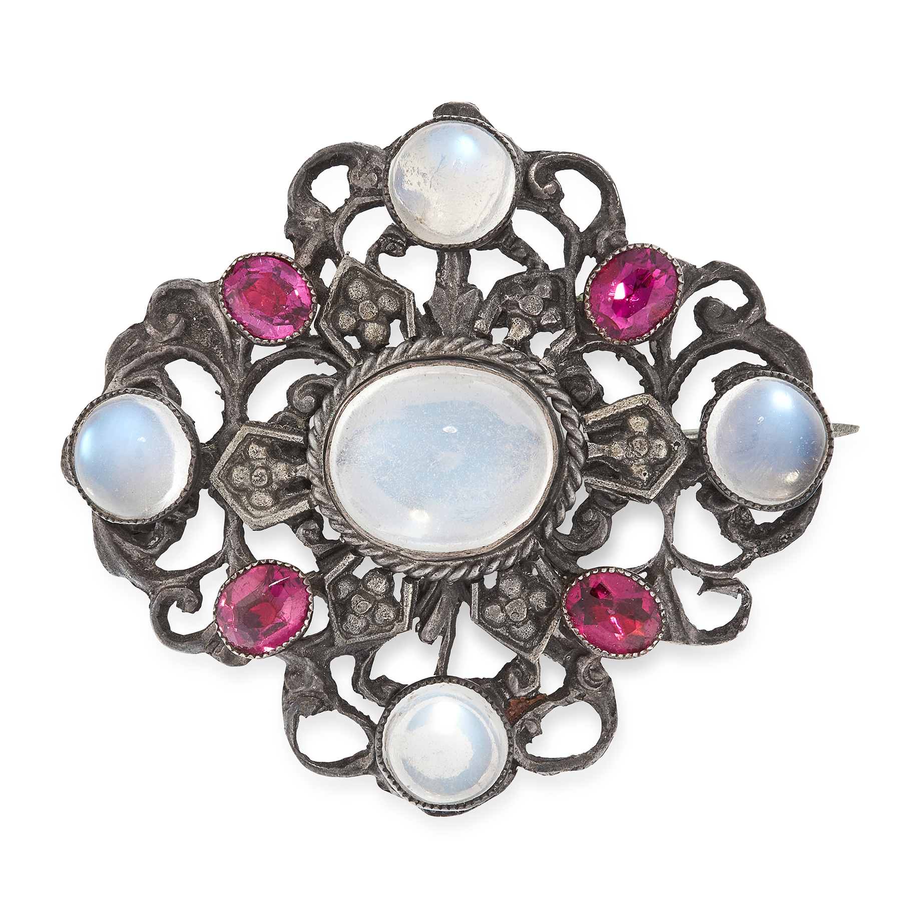 AN ANTIQUE MOONSTONE AND PASTE BROOCH in silver, the open scrolling face set with five round