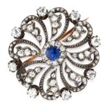 AN ANTIQUE SAPPHIRE AND DIAMOND BROOCH in yellow gold and silver, the scrolling circular face set