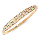 A VINTAGE OPAL AND DIAMOND BANGLE, TOD JEWELS 1975 in yellow gold, set with a row of nine