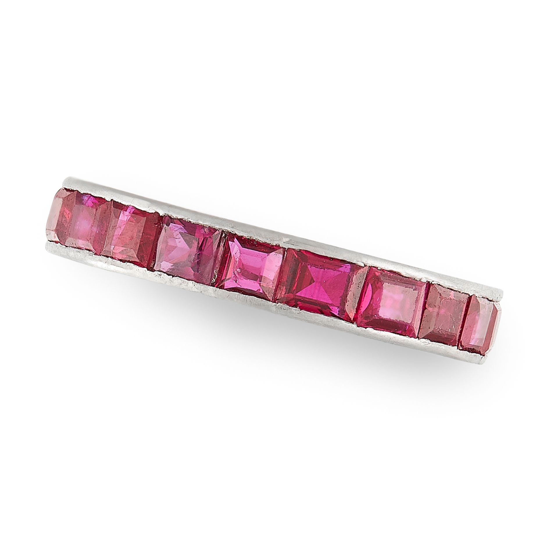 A RUBY ETERNITY RING in platinum, set with a single row of step cut rubies, French assay marks, size