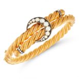 AN ANTIQUE PEARL CRESCENT BANGLE, 19TH CENTURY in 18ct yellow gold and silver, designed as an