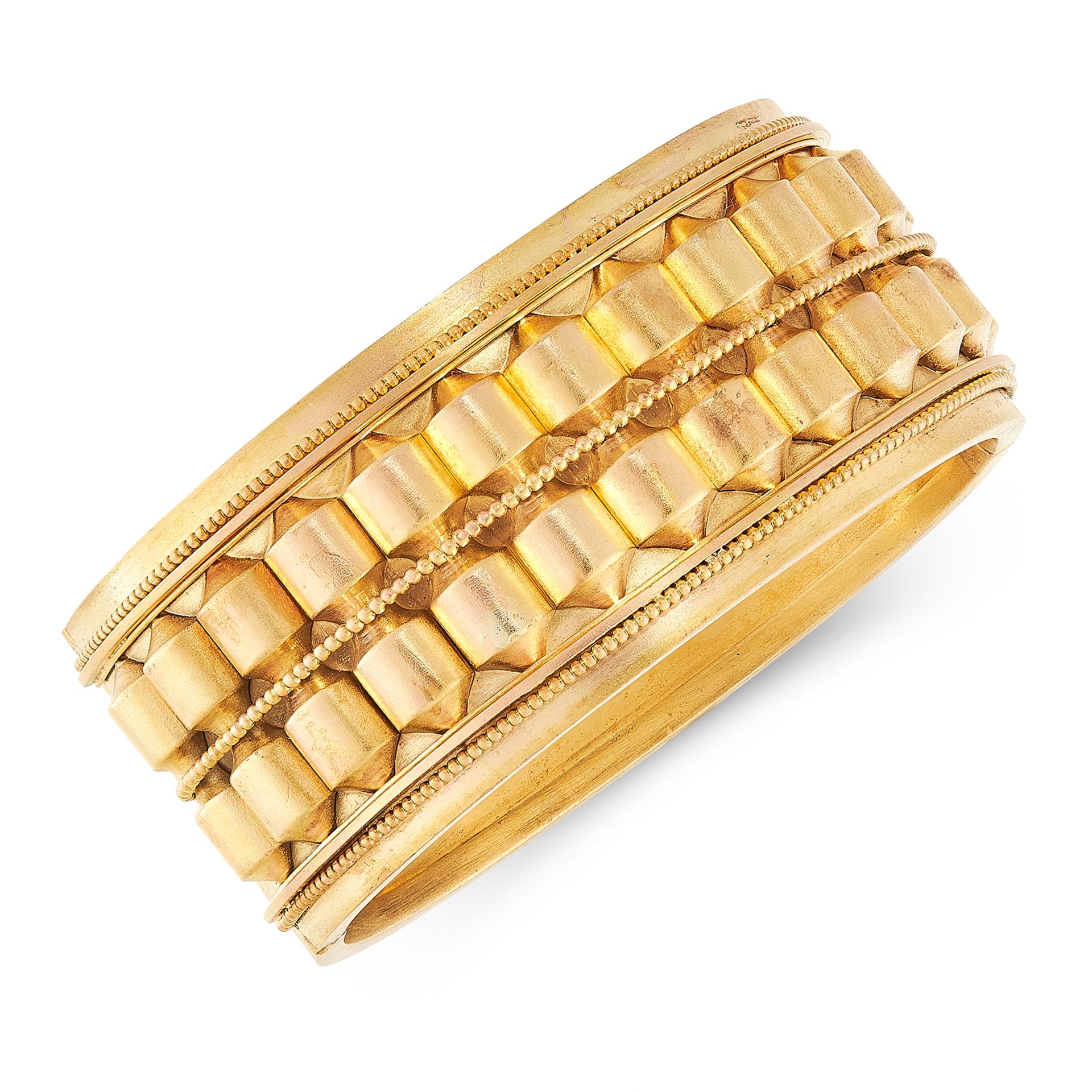 AN ANTIQUE CUFF BANGLE in high carat yellow gold, the body decorated to one side with barrel