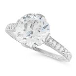 A SOLITAIRE DIAMOND RING set with an old European cut diamond of 3.09 carats, with further single