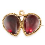 AN ANTIQUE GARNET BROOCH, 19TH CENTURY in high carat yellow gold, set with two cabochon garnets in