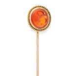 AN ANTIQUE CARNELIAN INTAGLIO STICK / TIE PIN in yellow gold, the pin surmounted by a carved