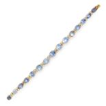 A SAPPHIRE AND DIAMOND BRACELET in yellow gold, comprising a row of fifteen graduated oval cut