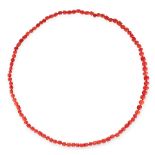 A CORAL BEAD NECKLACE comprising a row of graduated naturalistic polished coral beads ranging 10.8mm