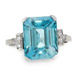 A ZIRCON AND DIAMOND DRESS RING set with an emerald cut blue zircon of 7.97 carats, between