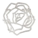 A DIAMOND ROSE BANGLE, AVELLO in 18ct white gold, the open framework depicts a rose, set with