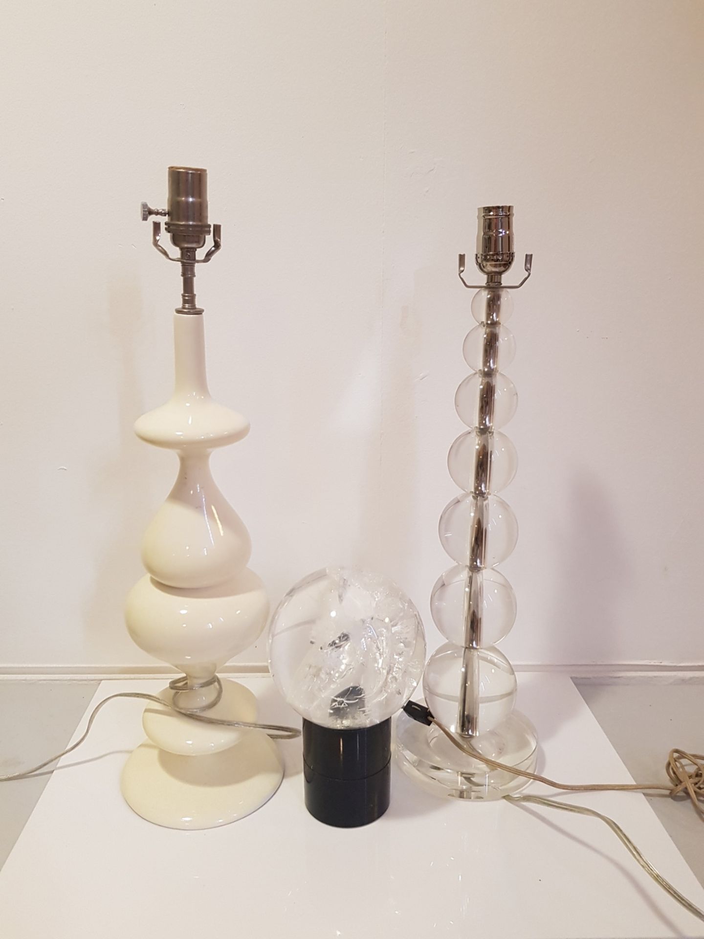 TWO TWENTIETH CENTURY LAMP BASES together with a plastic sphere lamp.