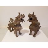A pair of east Asian style cast base metal standing lions