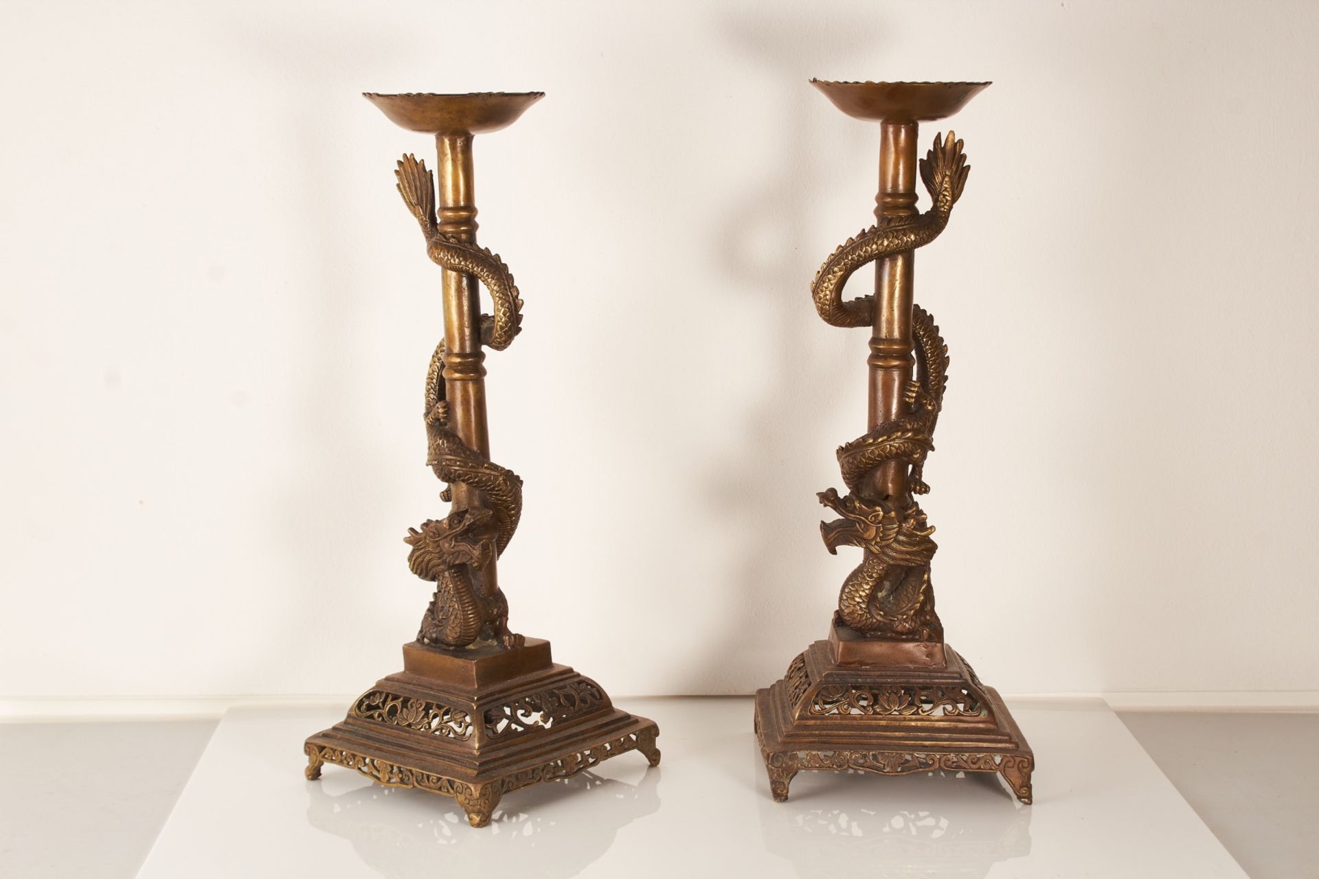 A pair of 20th century Chinese base metal candle stands