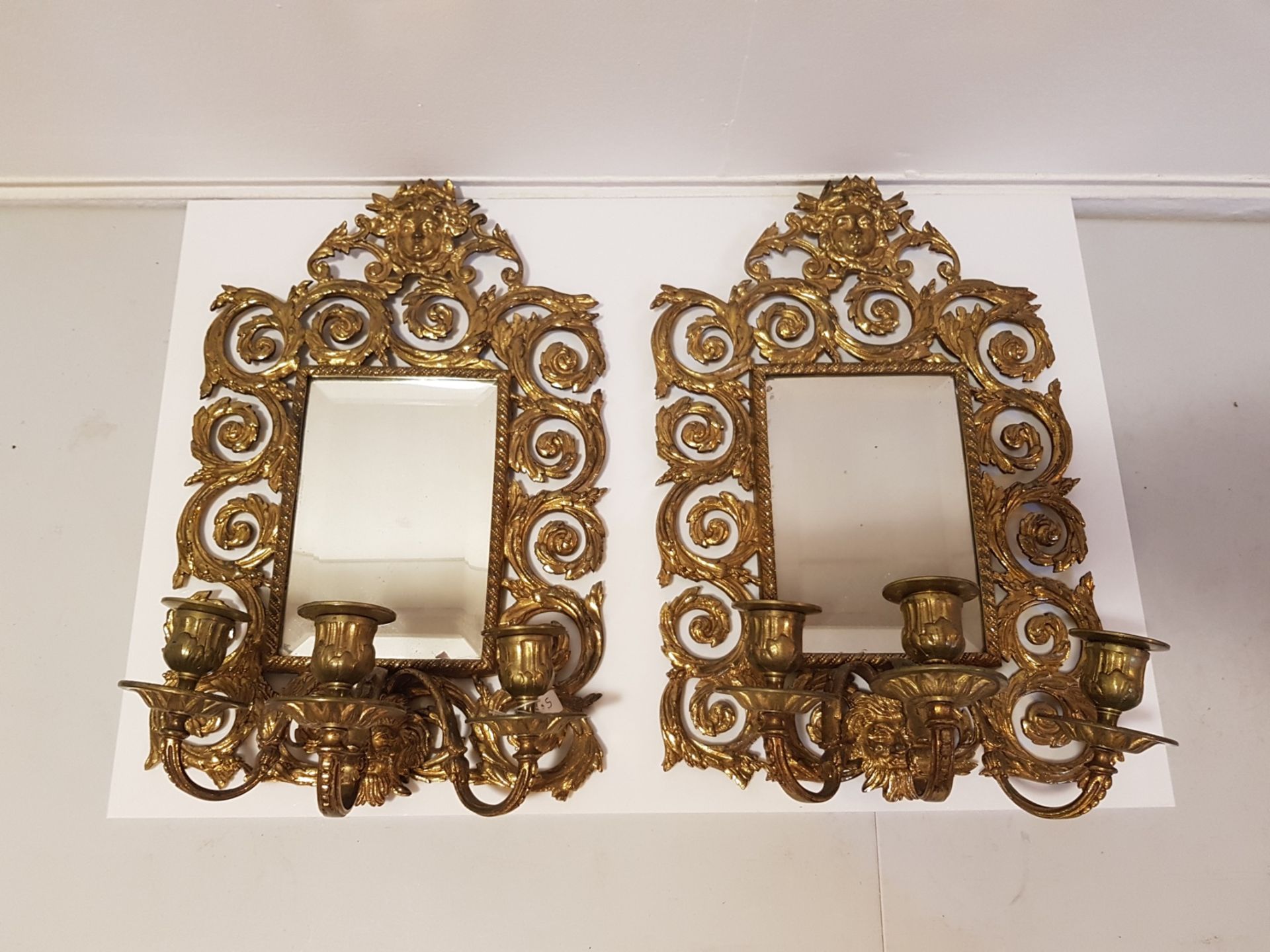 A pair of 20th century gilt brass girandole mirrors