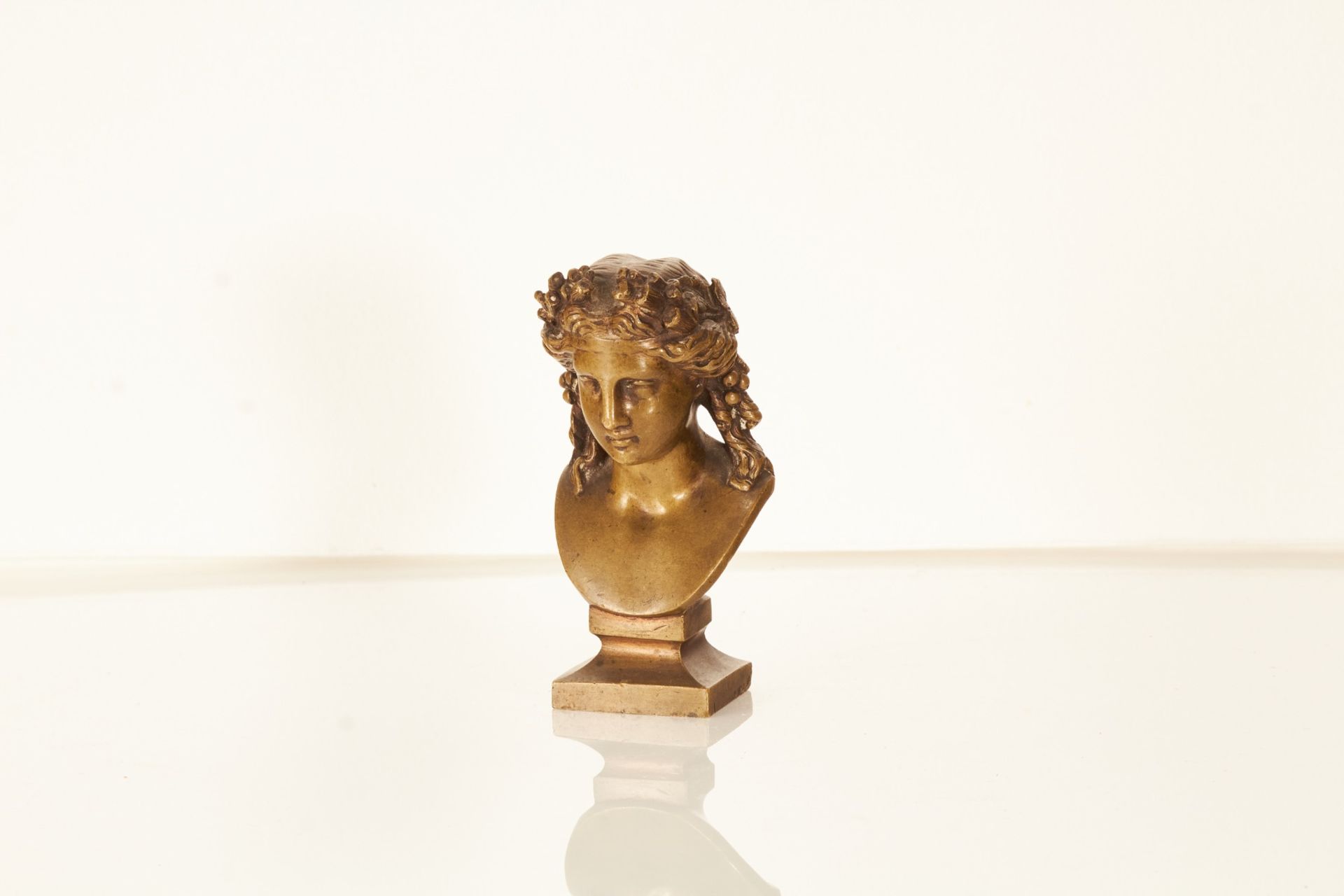 A late 19th century bronze bust of a woman as an allegory of summer