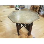 AN INDIAN WOODEN AND BRASS SIDE TABLE of octagonal design with flat chased decoration to the