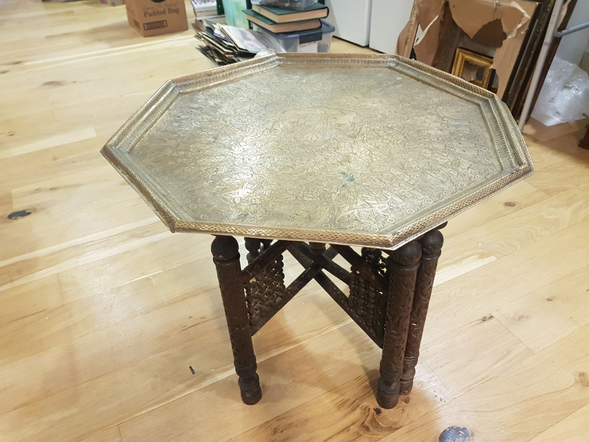 AN INDIAN WOODEN AND BRASS SIDE TABLE of octagonal design with flat chased decoration to the