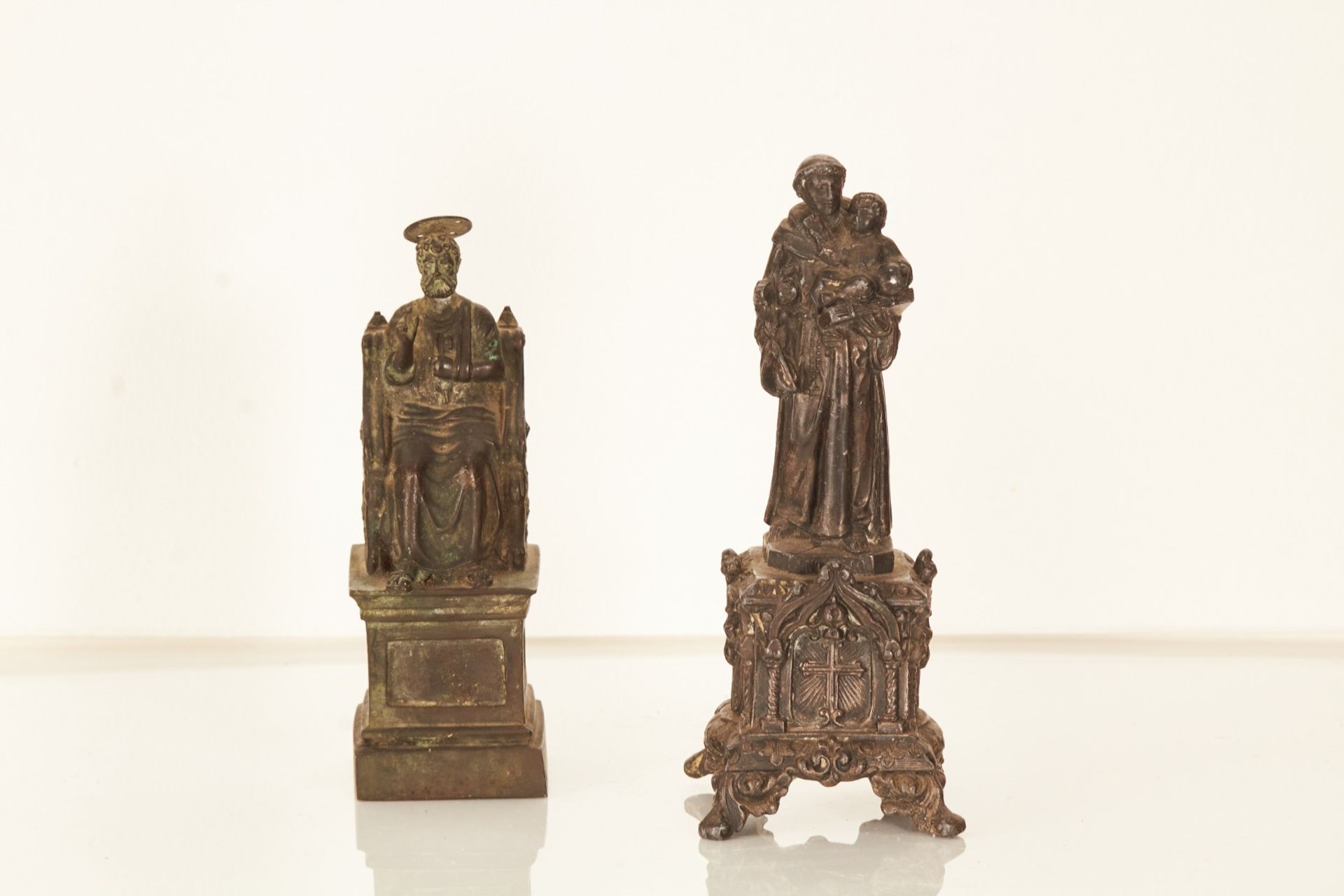 A 20th century bronze sculpture of a seated saint