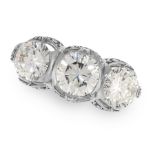 A DIAMOND THREE STONE RING set with a trio of round cut diamonds, the largest of 1.01 carats,