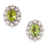 A PAIR OF PERIDOT AND DIAMOND CLUSTER EARRINGS in yellow gold, each set with an oval cut peridot