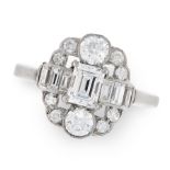 A DIAMOND DRESS RING in platinum, set with a central emerald cut diamond of 0.52 carats, flanked