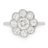 A DIAMOND CLUSTER RING set with a central round cut diamond within a border of further diamonds, all