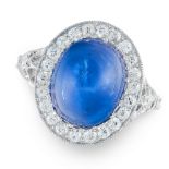 A SAPPHIRE AND DIAMOND CLUSTER RING in platinum, set with an oval cabochon sapphire of 8.49 carats