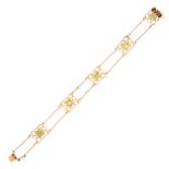 AN ART NOUVEAU PERIDOT BRACELET, EARLY 20TH CENTURY in 15ct yellow gold, set with five emerald cut