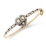 AN ANTIQUE PEARL AND DIAMOND SWEETHEART BANGLE in yellow gold and silver, the bifurcated band