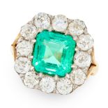 A COLOMBIAN EMERALD AND DIAMOND CLUSTER RING in 18ct yellow gold and silver, set with an emerald cut