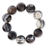 A BANDED AGATE BEAD BRACELET comprising of eleven beads 19.5mm in diameter, elasticated, 112.7g.