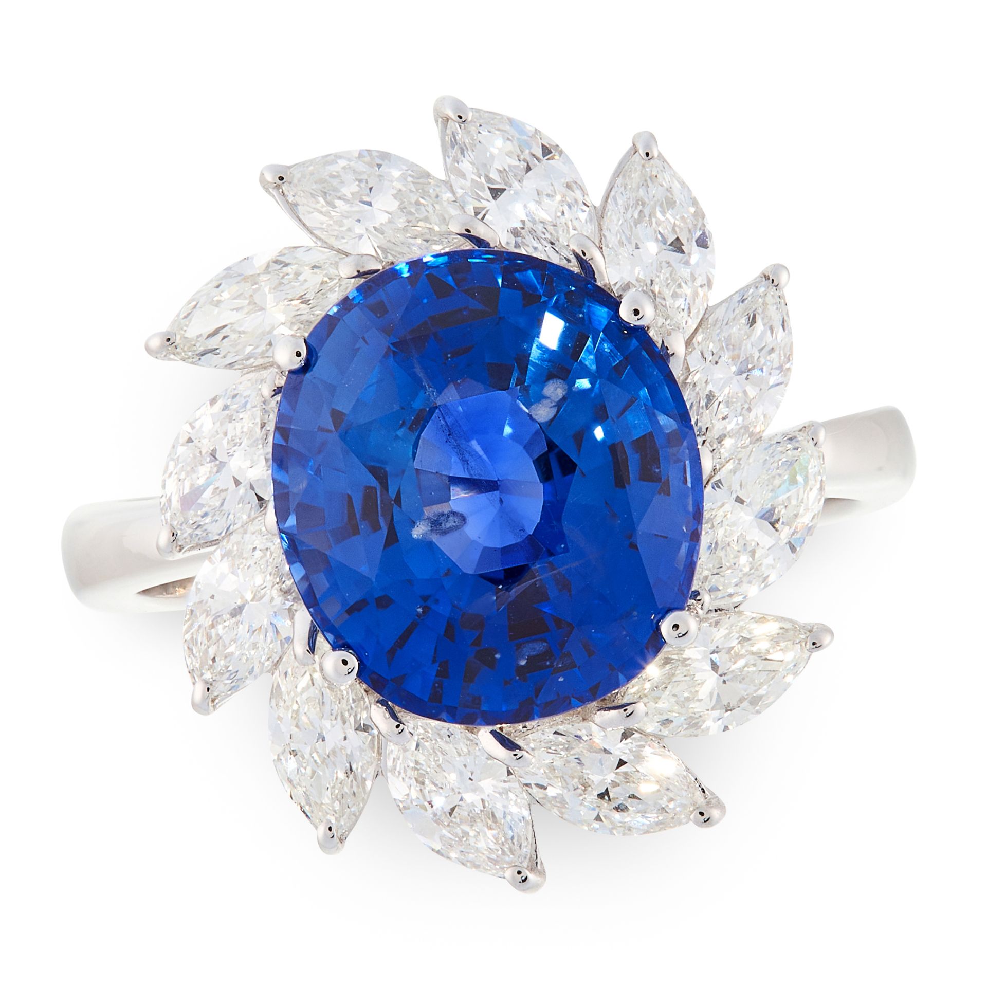 A SAPPHIRE AND DIAMOND CLUSTER RING in 18ct white gold, set with an oval cut sapphire of 6.77 carats