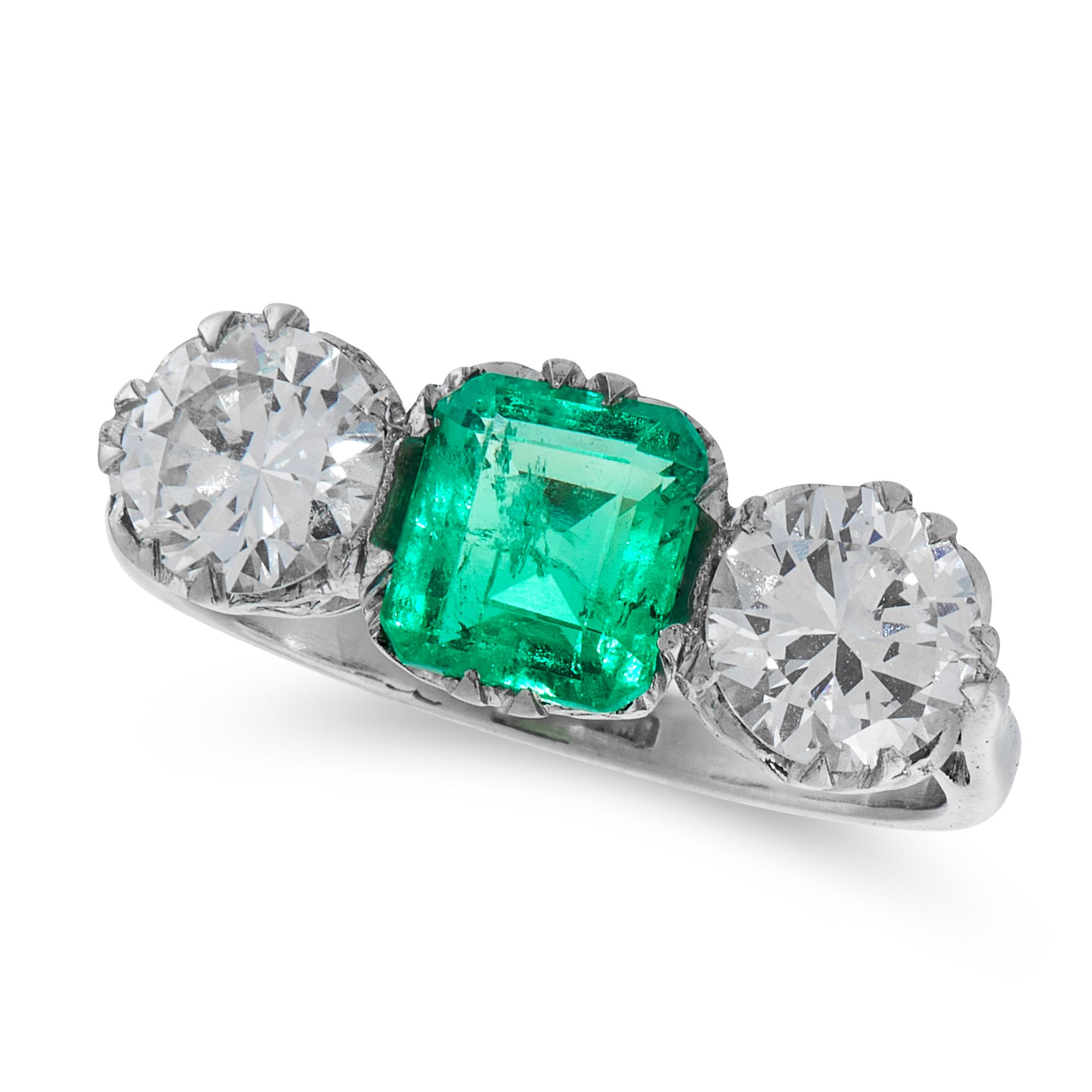 A COLOMBIAN EMERALD AND DIAMOND RING in platinum, set with a cushion cut emerald between two round