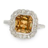 A YELLOW DIAMOND AND WHITE DIAMOND RING in 18ct white gold and platinum, set with an asscher cut