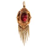 AN ANTIQUE VICTORIAN GARNET PENDANT in yellow gold, the oval face is set with a cabochon garnet