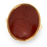 AN ANTIQUE CARNELIAN INTAGLIO SEAL RING, 1868 in 18ct yellow gold, the face set with an oval