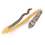 AN ANTIQUE DIAMOND AND RUBY SNAKE BANGLE in yellow gold and silver, designed as a snake coiled