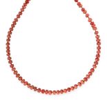 A CORAL BEAD NECKLACE comprising a single row of polished coral beads ranging from 9.6mm-13.2mm on a