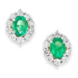 A PAIR OF EMERALD AND DIAMOND CLUSTER EARRINGS in 18ct white gold, each set with an oval cut emerald