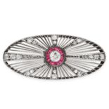 A RUBY AND DIAMOND BROOCH in oval, open framework design, set with a central round cut diamond of
