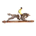 AN ANTIQUE DIAMOND AND ENAMEL HORSE AND JOCKEY BAR BROOCH in yellow gold and silver, comprising of a